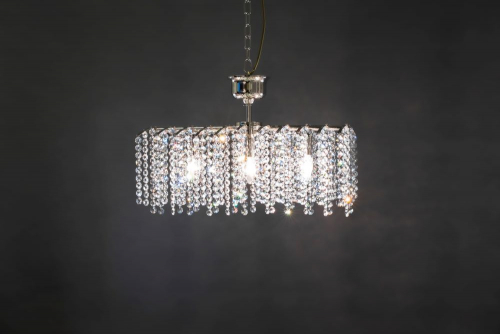 Rake 5 is an individual crystal luminaire with hanging crystal ribbons, three light points, and a nickel-plated body.